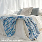 Customisable bed throw and blanket with your own name knitted in sky blue and white, made by TinyBitz!