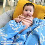 TinyBitz personalized knitted blanket in sky blue background, customized with baby's name and made from 100% cotton.