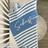 TinyBitz custom knitted blanket with baby's name on sky blue background with a stripes pattern, best gift to welcome a newborn baby.