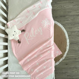 Knitted baby blanket in light pink and white with a twinkles pattern, customised with baby's name, made by TinyBitz.