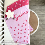 Knitted baby blanket in light purple and rose pink with a twinkles pattern, customised with baby's name, made by TinyBitz.
