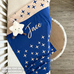 TinyBitz personalized kids knitted name blanket in blue background with a twinkles pattern, perfect gift for birthdays!