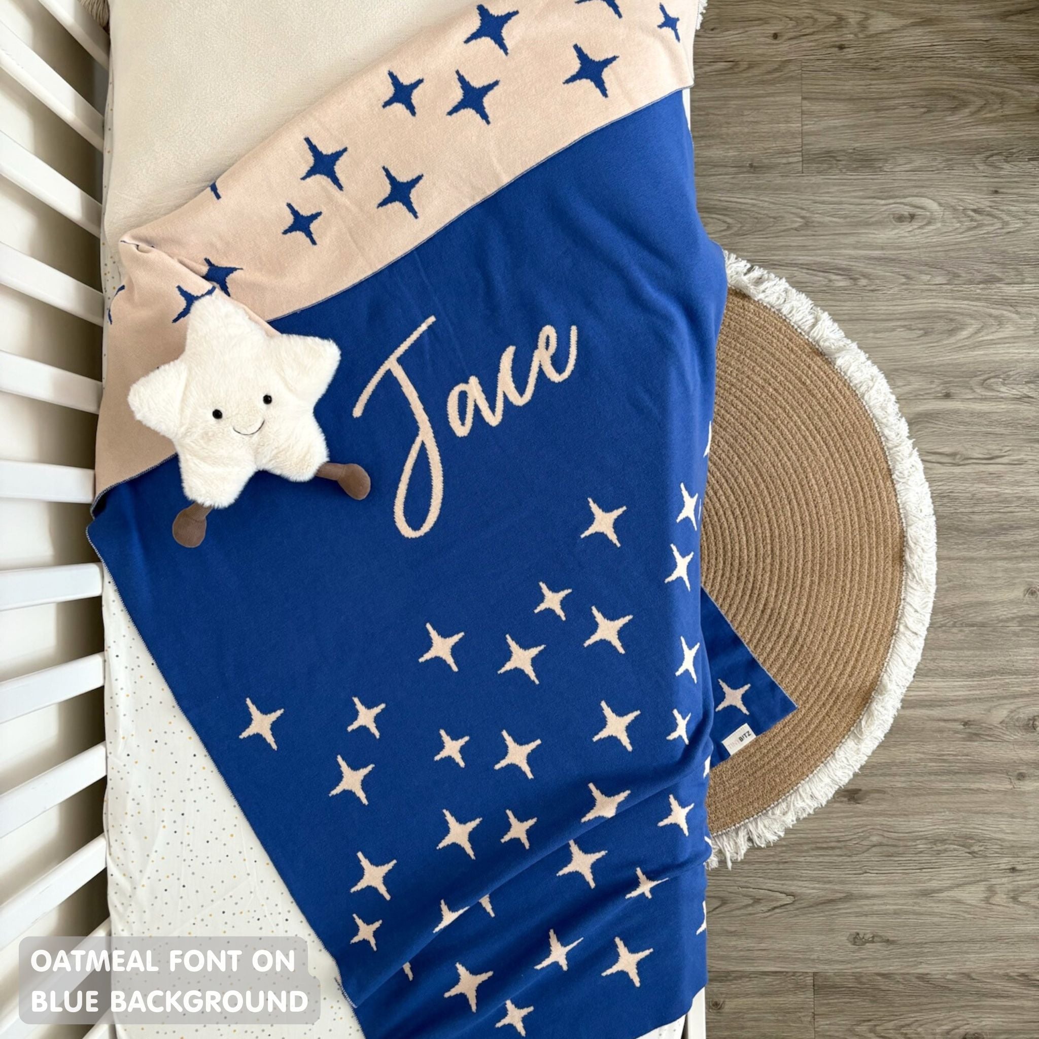 TinyBitz personalized kids knitted name blanket in blue background with a twinkles pattern, perfect gift for birthdays!