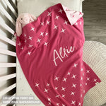 Cotton baby blanket with baby's name knitted in rose pink and light pink with a twinkles pattern, made by TinyBitz.