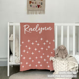 Baby blanket knitted from cotton personalized with baby's name in dusty pink and white with a twinkles pattern, made by TinyBitz.