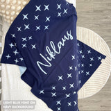Knitted baby blanket in navy and light blue with a twinkles pattern, customised with baby's name, made by TinyBitz.