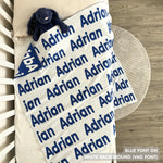 Baby blanket knitted from cotton personalized with baby's name in white and blue, made by TinyBitz.
