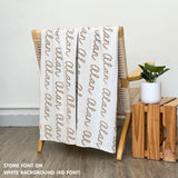 Custom name blanket in white and stone draped over a chair makes the best personalized home decor.