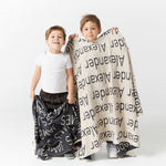 TinyBitz Kids Blanket in charcoal and oatmeal, personalized with child's name and made from 100% cotton.