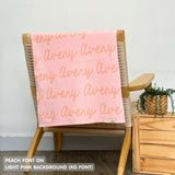 TinyBitz knitted cotton blanket in light pink and peach, personalized with your kid’s name.