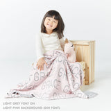 TinyBitz knitted cotton blanket in light pink and light grey, personalized with your kid’s name.