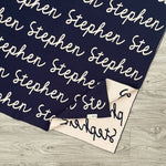 TinyBitz knitted cotton blanket in navy and oatmeal, personalized with your kid’s name.