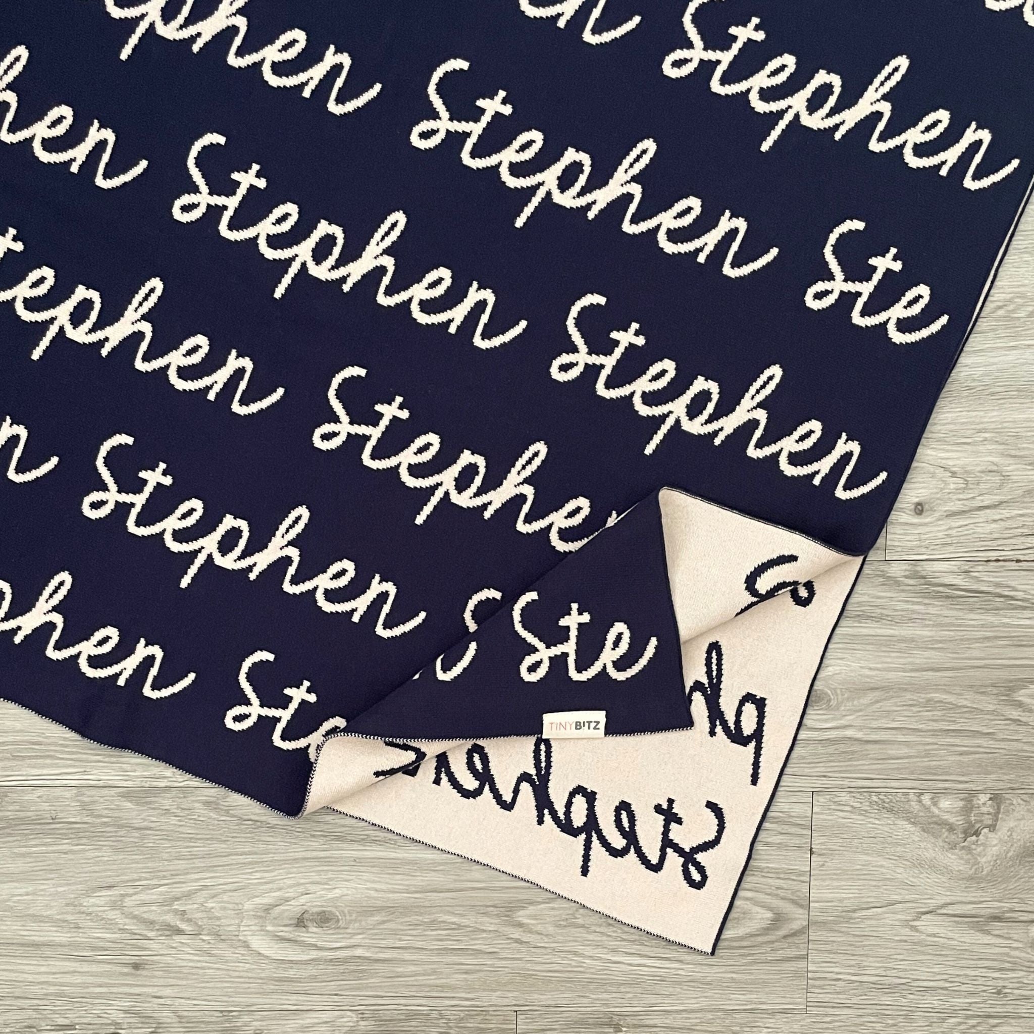 TinyBitz knitted cotton blanket in navy and oatmeal, personalized with your kid’s name.