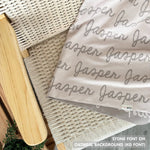 TinyBitz knitted cotton blanket in oatmeal and stone, personalized with your kid’s name.