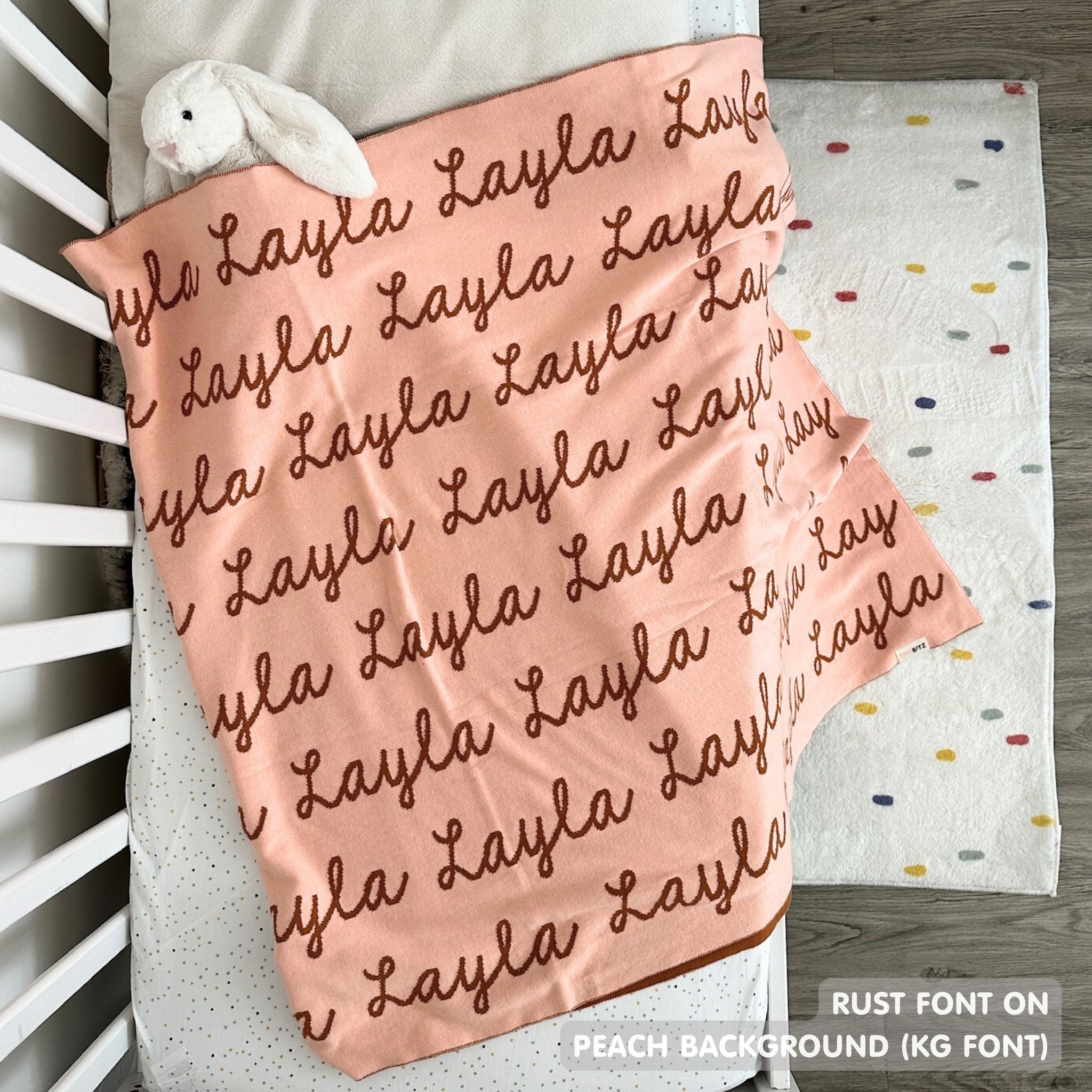 TinyBitz knitted cotton blanket in peach and ruse, personalized with your kid’s name.