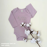 Organic cotton baby onesie with custom name, ideal for birth announcements, baby shower gifts, and keepsakes by TinyBitz.