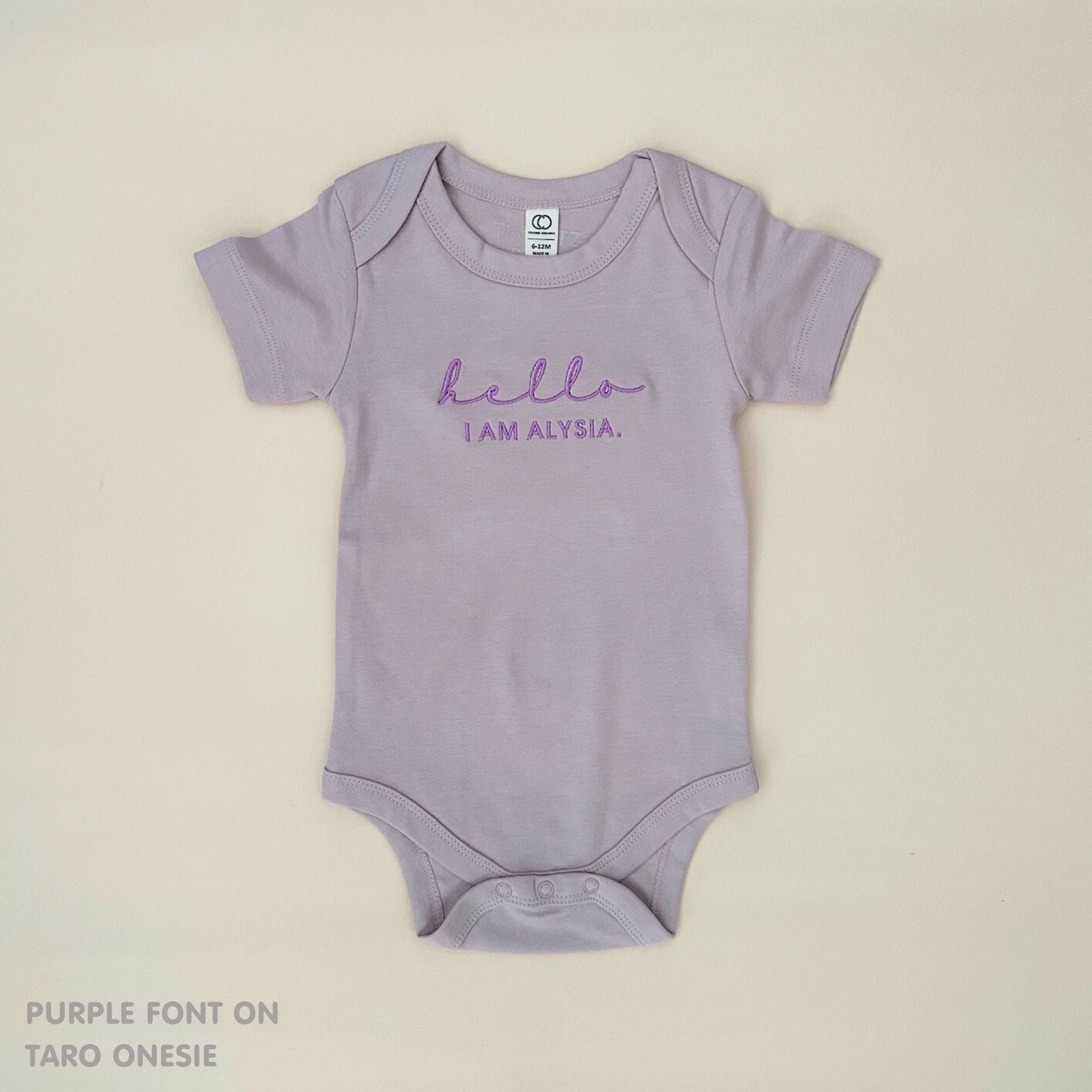 TinyBitz Personalised baby onesie with embroidered name in soft taro cotton, perfect for birth announcements and newborn photos.