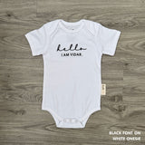 Neutral-tone personalised baby onesie featuring custom name, made-to-order newborn gift by TinyBitz.
