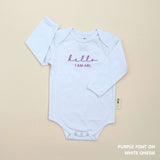 Minimalist personalised onesie in neutral tones with name embroidery, styled for newborn birth announcements by TinyBitz.