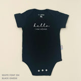 Organic cotton baby onesie with custom name, ideal for birth announcements, baby shower gifts, and keepsakes by TinyBitz.
