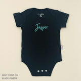Organic cotton black onesie for babies with embroidered name, personalized baby shower gift keepsake from TinyBitz.