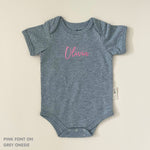 TinyBitz Personalised baby onesie with embroidered name in soft grey cotton, perfect for birth announcements and newborn photos.