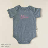 TinyBitz Personalised baby onesie with embroidered name in soft grey cotton, perfect for birth announcements and newborn photos.