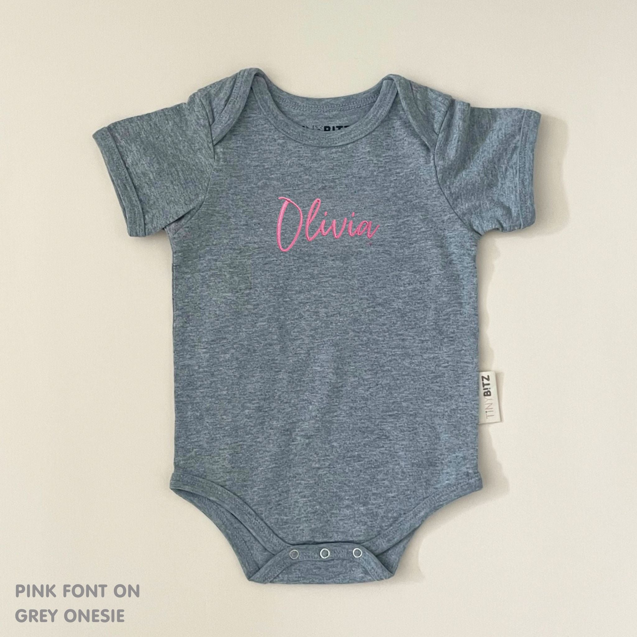 TinyBitz Personalised baby onesie with embroidered name in soft grey cotton, perfect for birth announcements and newborn photos.