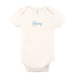Minimalist personalised onesie in neutral tones with name embroidery, styled for newborn birth announcements by TinyBitz.