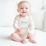TinyBitz Custom baby onesie in cream with name embroidery, unique outfit for baby’s birth announcement or first photoshoot.