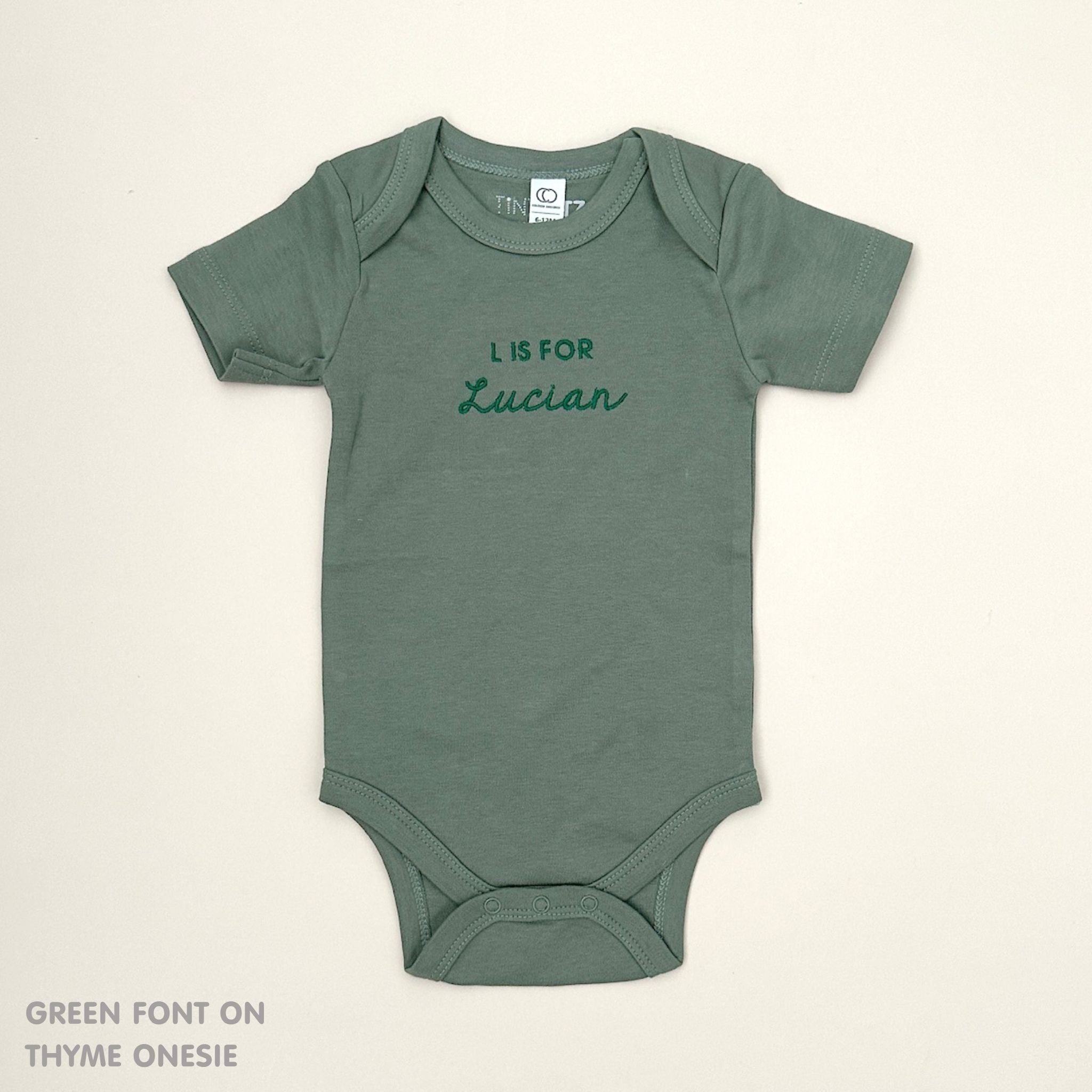 Organic cotton baby onesie with custom name, ideal for birth announcements, baby shower gifts, and keepsakes by TinyBitz.