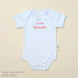 TinyBitz Personalised baby onesie with embroidered name in soft white cotton, perfect for birth announcements and newborn photos.
