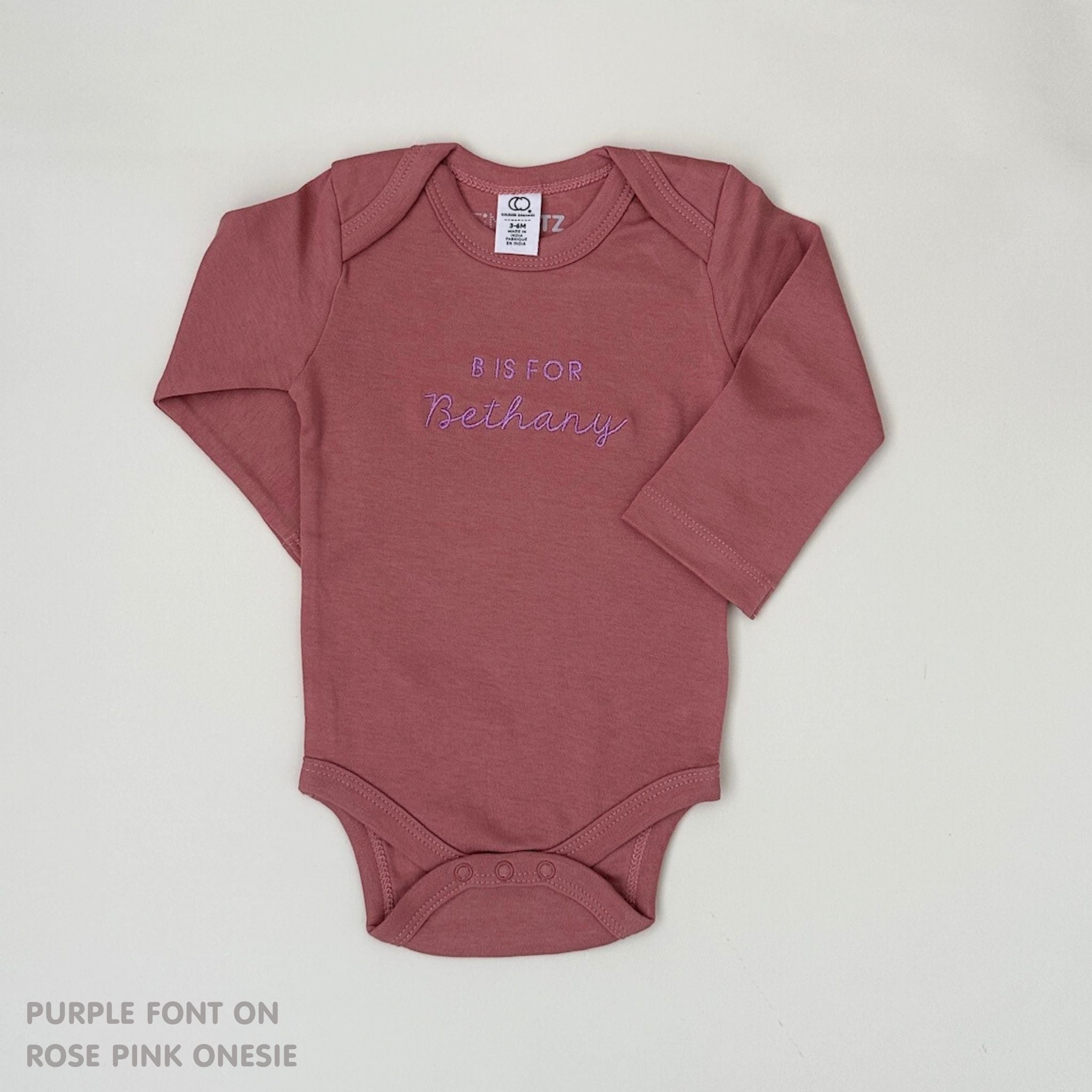 Custom name onesie in rose pink, personalised baby clothing made with soft breathable fabric by TinyBitz.