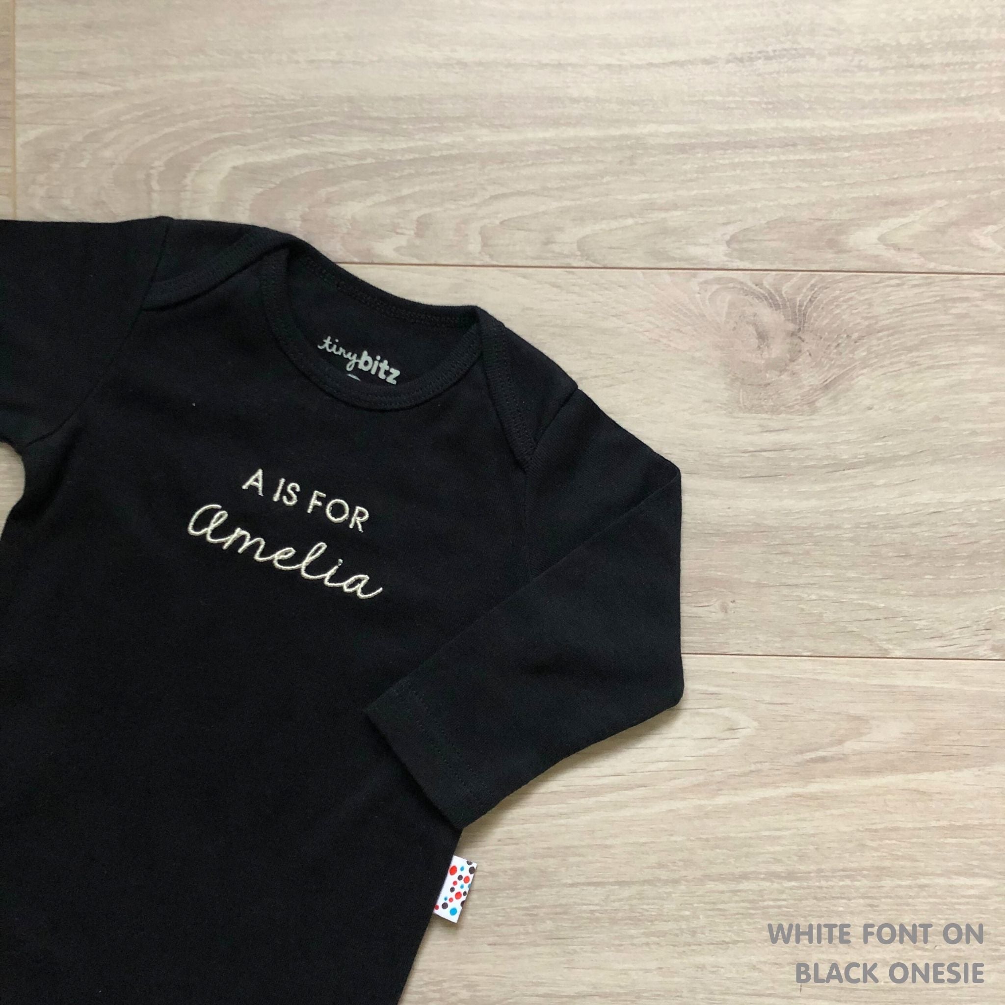 Custom name onesie in black, personalised baby clothing made with soft breathable fabric by TinyBitz.