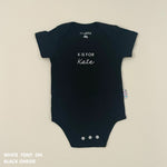 Organic cotton baby onesie with custom name, ideal for birth announcements, baby shower gifts, and keepsakes by TinyBitz.