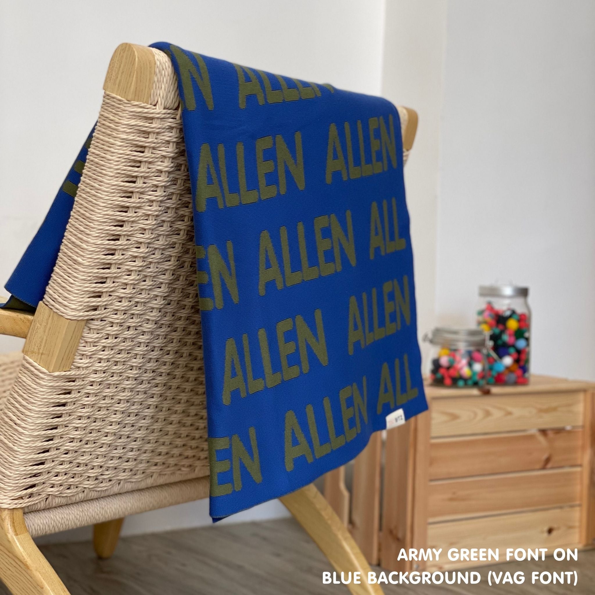 Personalised pet blanket in blue and army green knitted cotton, custom dog blanket by TinyBitz, styled on modern wooden dog bed.