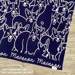Personalised pet blanket for Corgi in navy and light purple knitted cotton, custom dog blanket by TinyBitz, styled on modern wooden dog bed.