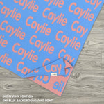 Personalised pet blanket for in sky blue and dusty pink knitted cotton, custom dog blanket by TinyBitz, styled on modern wooden dog bed.