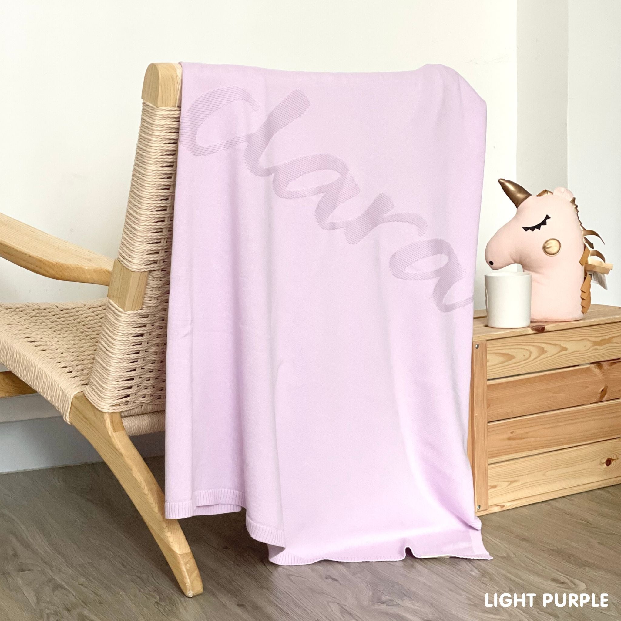 TinyBitz Personalized baby knitted name blanket in light purple background, making the best baby shower gift!