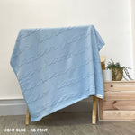 Baby blanket knitted from cotton personalized with baby's name in light blue, one colour with monogram, made by TinyBitz.