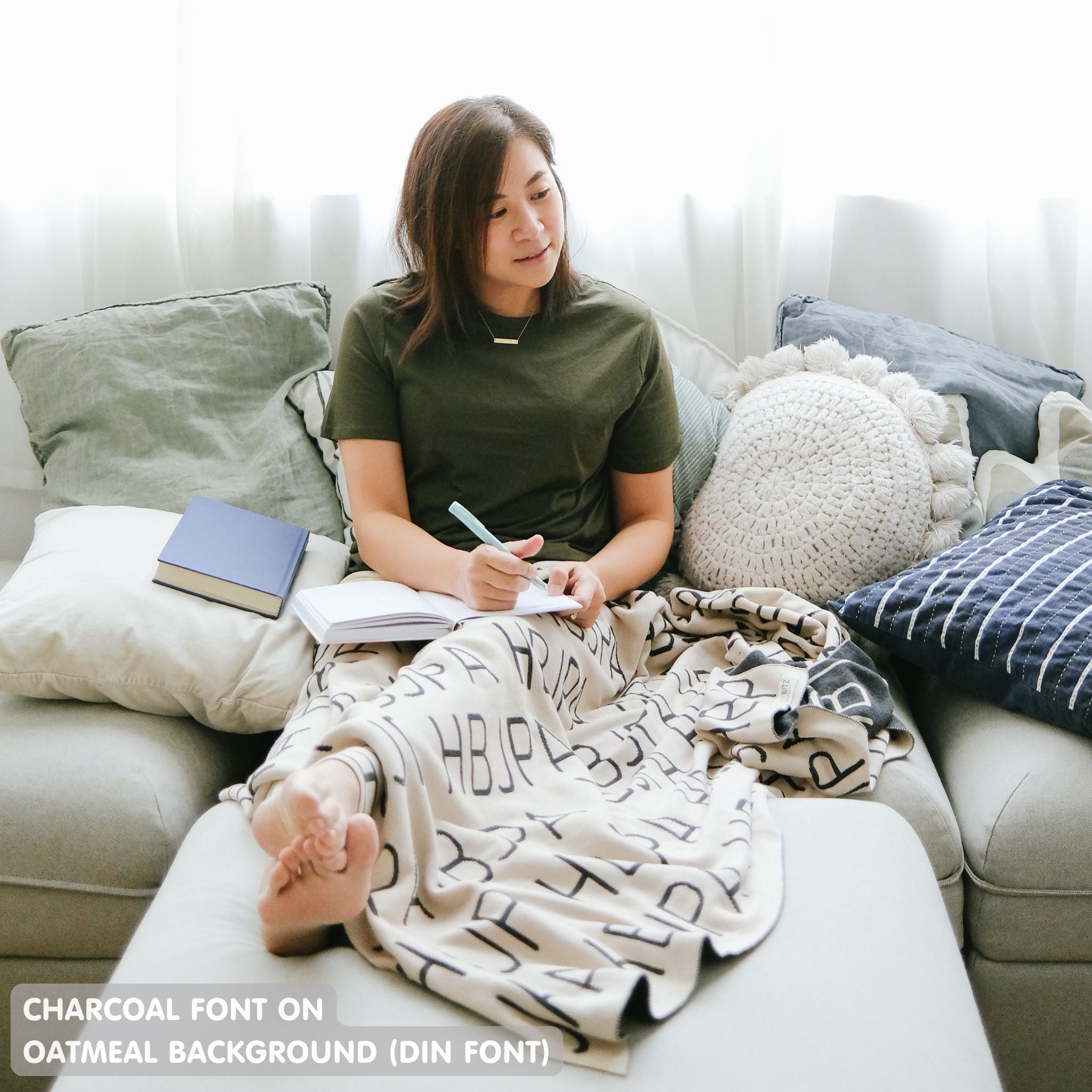 Customisable sofa throw and blanket with your own name knitted in oatmeal and charcoal, made by TinyBitz!