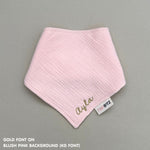 Personalized blush pink organic muslin bib with custom name embroidery, perfect for baby gifts and keepsake accessories.