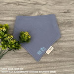 Personalized dusty blue organic muslin bib with custom name embroidery, perfect for baby gifts and keepsake accessories.