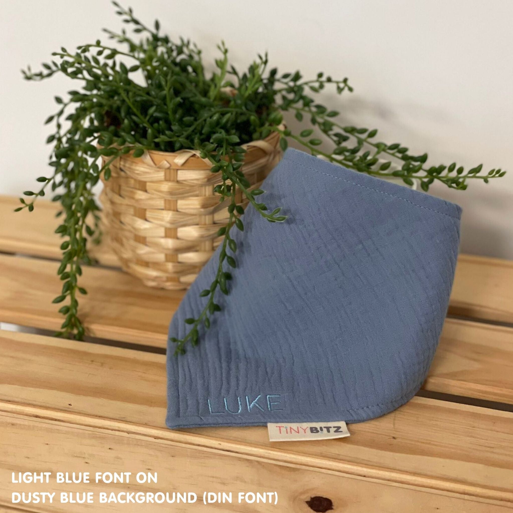 Organic personalised bib for babies in dusty blue, featuring baby name in script font, unique baby gift idea by TinyBitz.