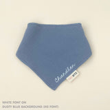 Custom baby bib in dusty blue with embroidered name, personalised baby gift made from breathable muslin by TinyBitz.