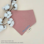 Custom baby bib in dusty pink with embroidered name, personalised baby gift made from breathable muslin by TinyBitz.