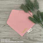 Personalized dusty pink organic muslin bib with custom name embroidery, perfect for baby gifts and keepsake accessories.