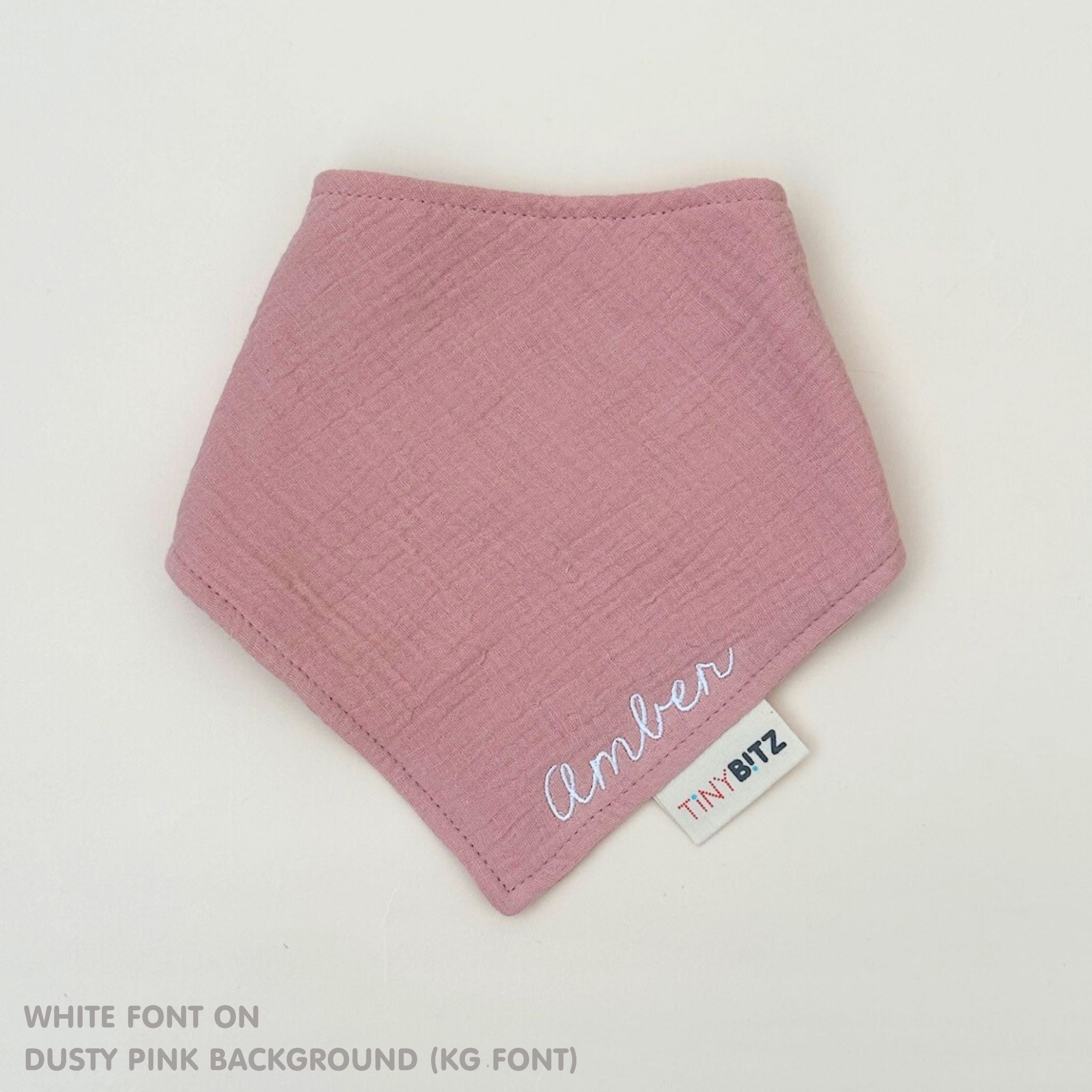 Organic personalised bib for babies in dusty pink, featuring baby name in script font, unique baby gift idea by TinyBitz.