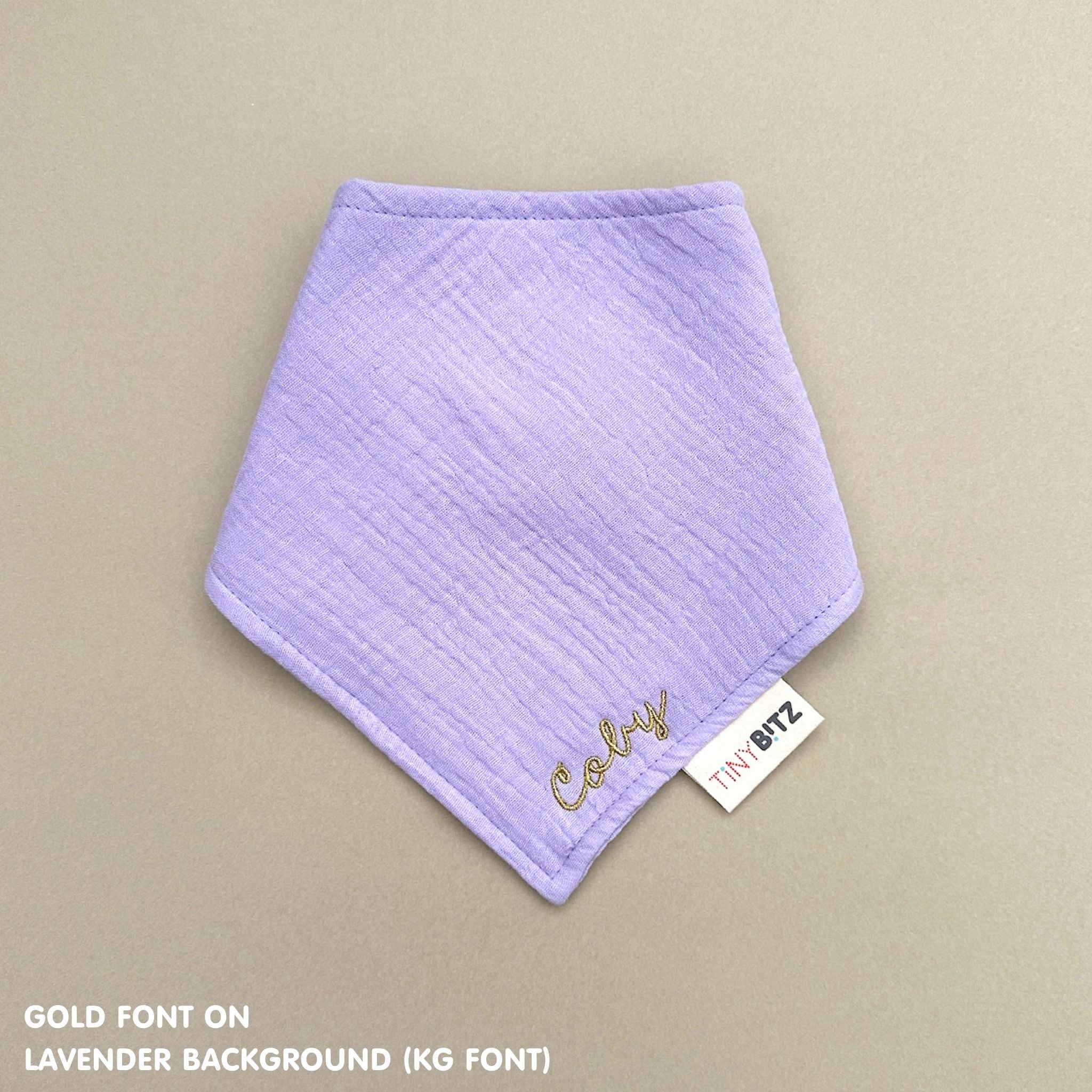 Personalized lavender organic muslin bib with custom name embroidery, perfect for baby gifts and keepsake accessories.