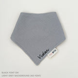 Organic personalised bib for babies in light grey, featuring baby name in script font, unique baby gift idea by TinyBitz.